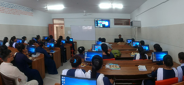 Young men and women learning computers