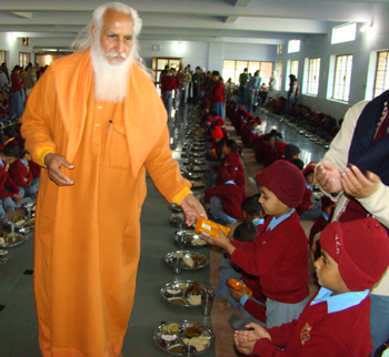 Swamiji distributing gifts to the school children