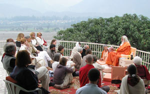 Swamiji and devotees sitting on the terrace during morning satsang